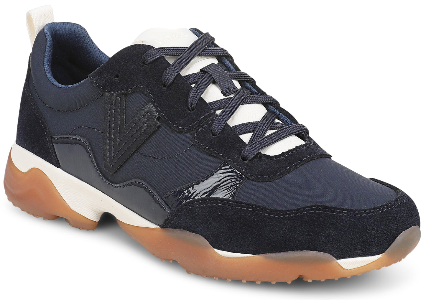 A low-top sneaker featuring navy blue suede and synthetic upper panels, a white tongue with dark blue laces, a V-shaped logo on the side, and a thick white midsole with a textured gum-rubber outsole.