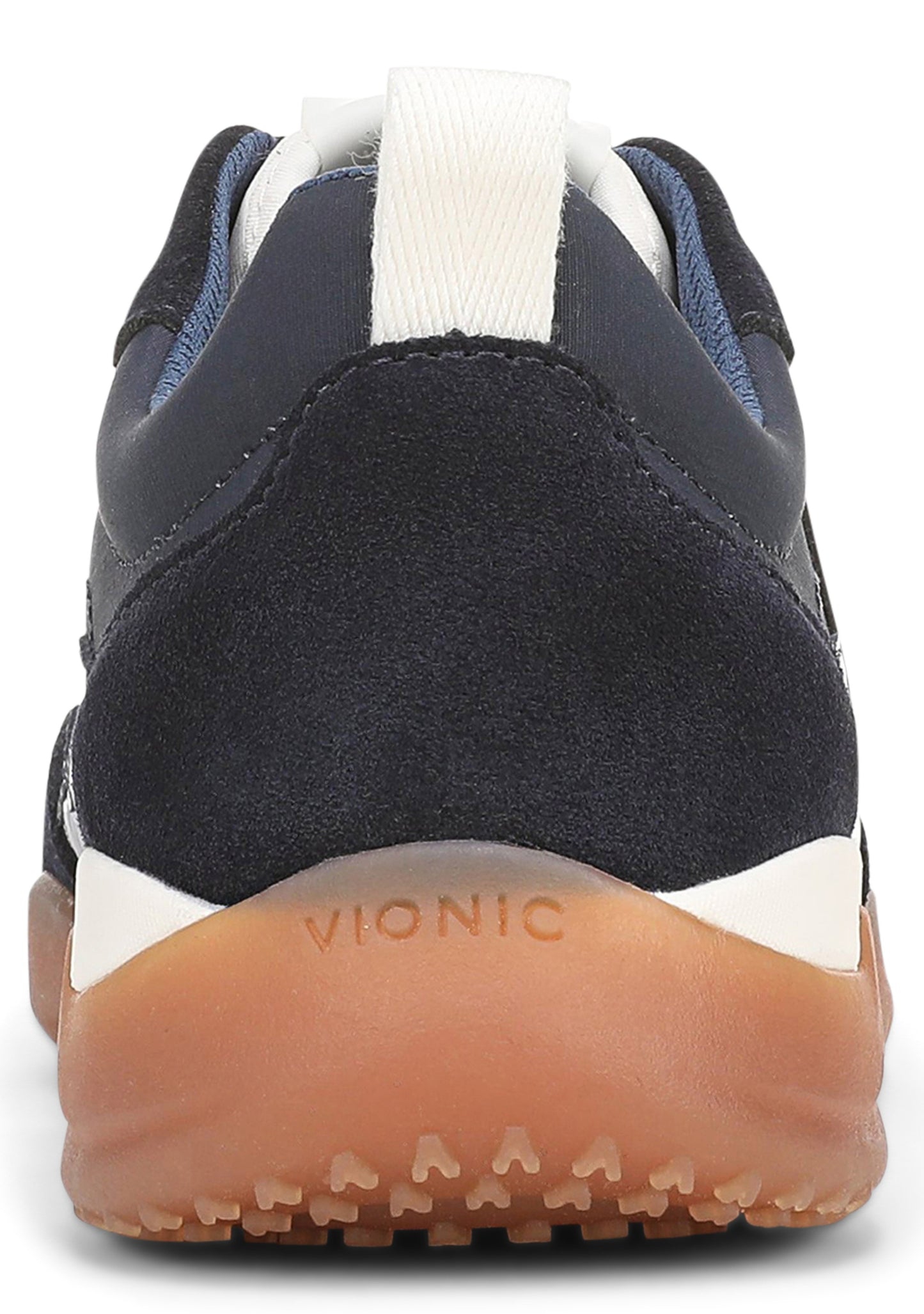 A close-up view of the heel of a dark navy blue sneaker, featuring a suede and smooth leather upper, a white midsole, and a gum-colored rubber outsole with the word VIONIC embossed on the back.