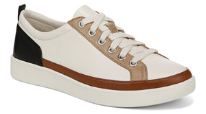 Off-white sneaker with white laces, brown trim and a black heel.
