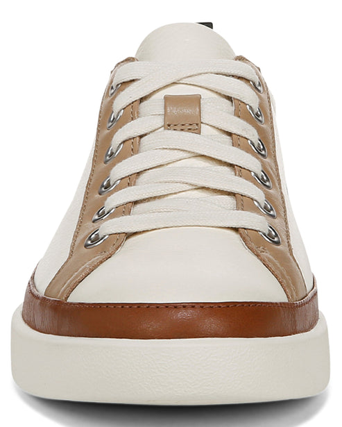 Low-top sneaker with ivory and brown trim and white laces.