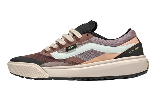 A low-profile, multi-panelled shoe in shades of brown, beige, peach, and lavender with a tan sole, white laces, and visible 'Vans' branding.
