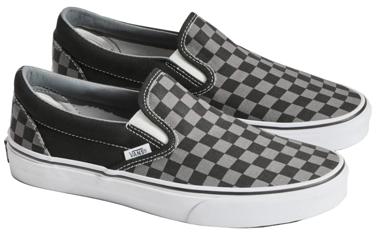 A pair of checkered slip-on shoes with white soles.