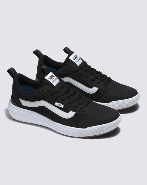 Two black sneakers with white curved stripes on a thick white sole, featuring a tongue label with white text.