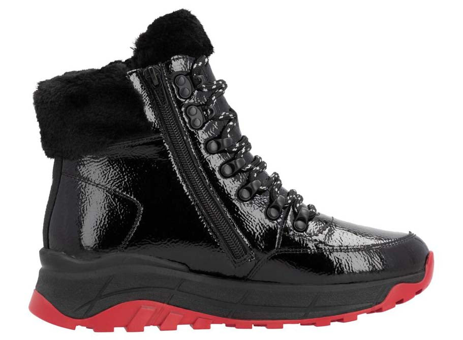 Black patent leather ankle boot with black faux fur trim, side zipper and red lug sole.
