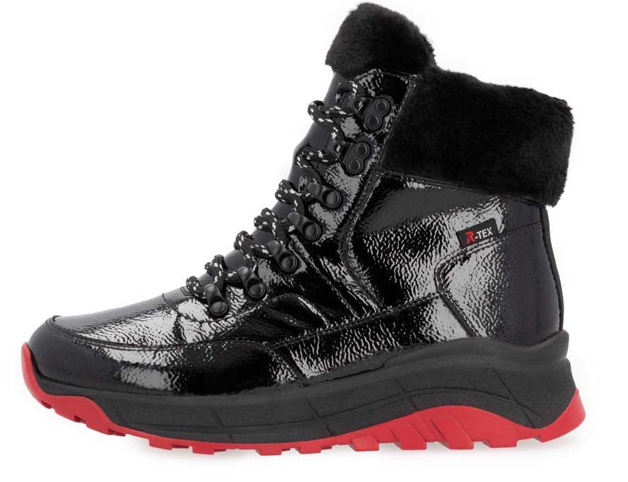 Black patent leather high-top boot with faux fur collar, lace-up closure and red sole.