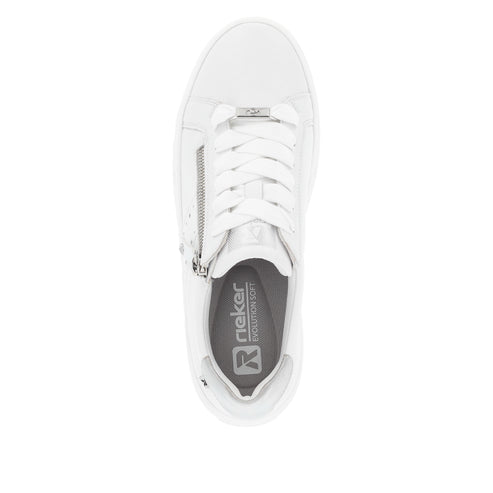 Top-down view of a white sneaker with white laces and a silver zipper, "rieker evolution soft" is visible on the inner sole.