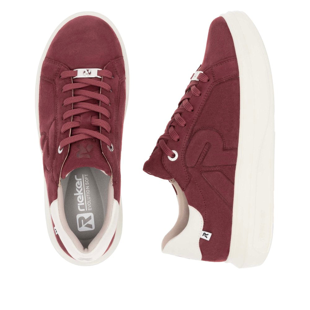 Two red sneakers with white soles and laces, top view and side view.