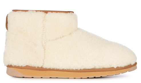 Cream-colored sheepskin boot with tan trim.