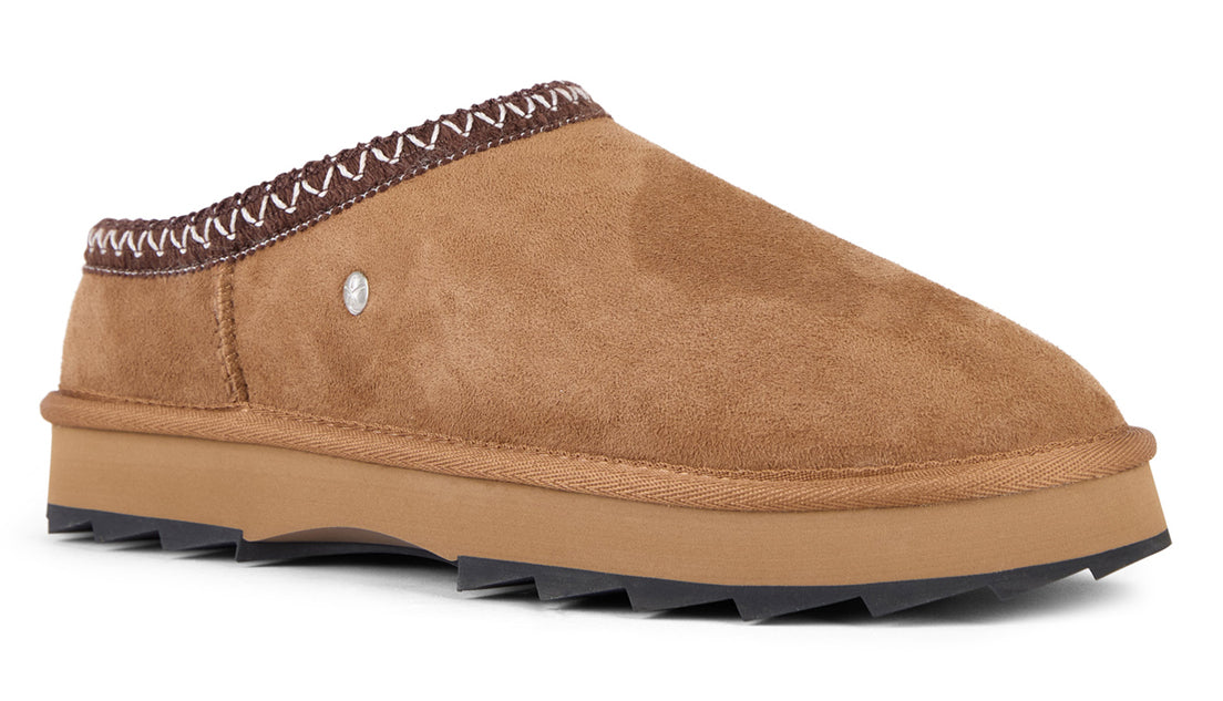 Tan colored suede clog-style slipper with brown and white zig-zag patterned trim.