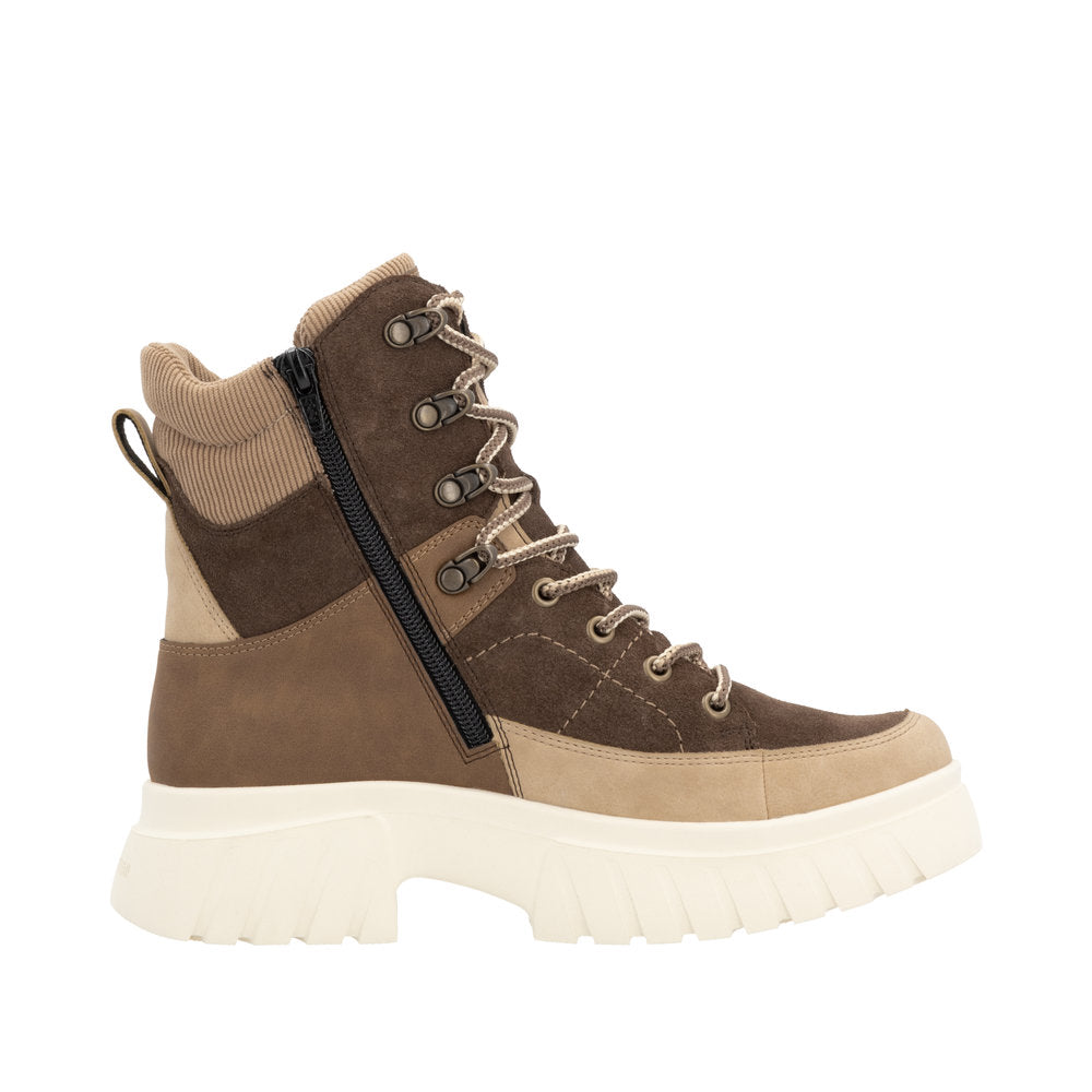 Side view of a light brown and dark brown lace-up hiking boot with a side zipper and a thick, white lug sole.