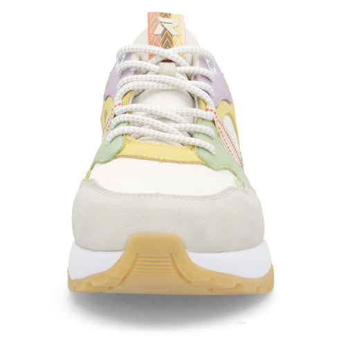 Front view of a white sneaker with colorful lavender, yellow, and green accents and a textured brown sole.