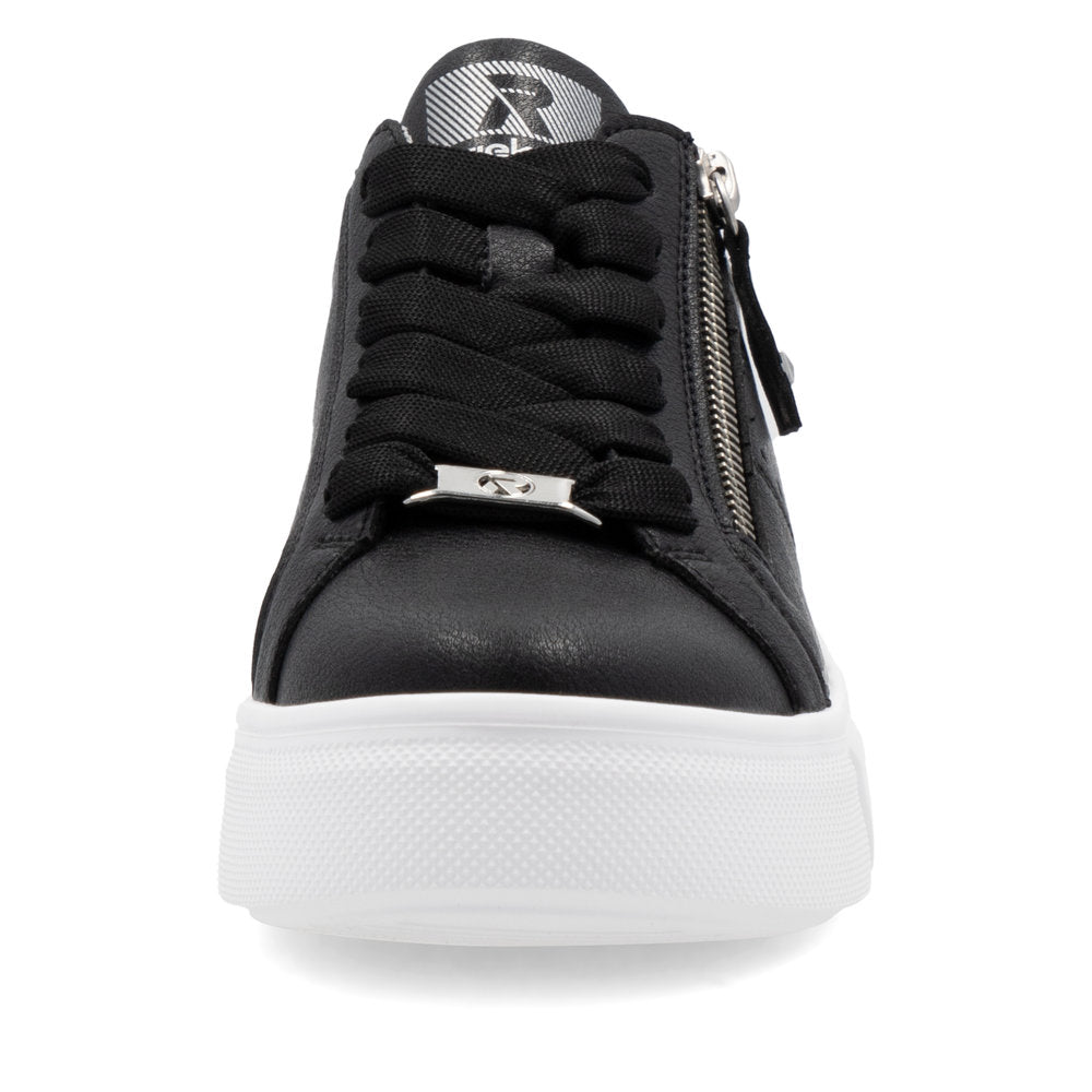 A black sneaker with a silver zipper and logo on the tongue.