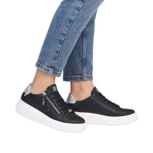 Black leather sneakers with white soles, zip closure, and silver heel.