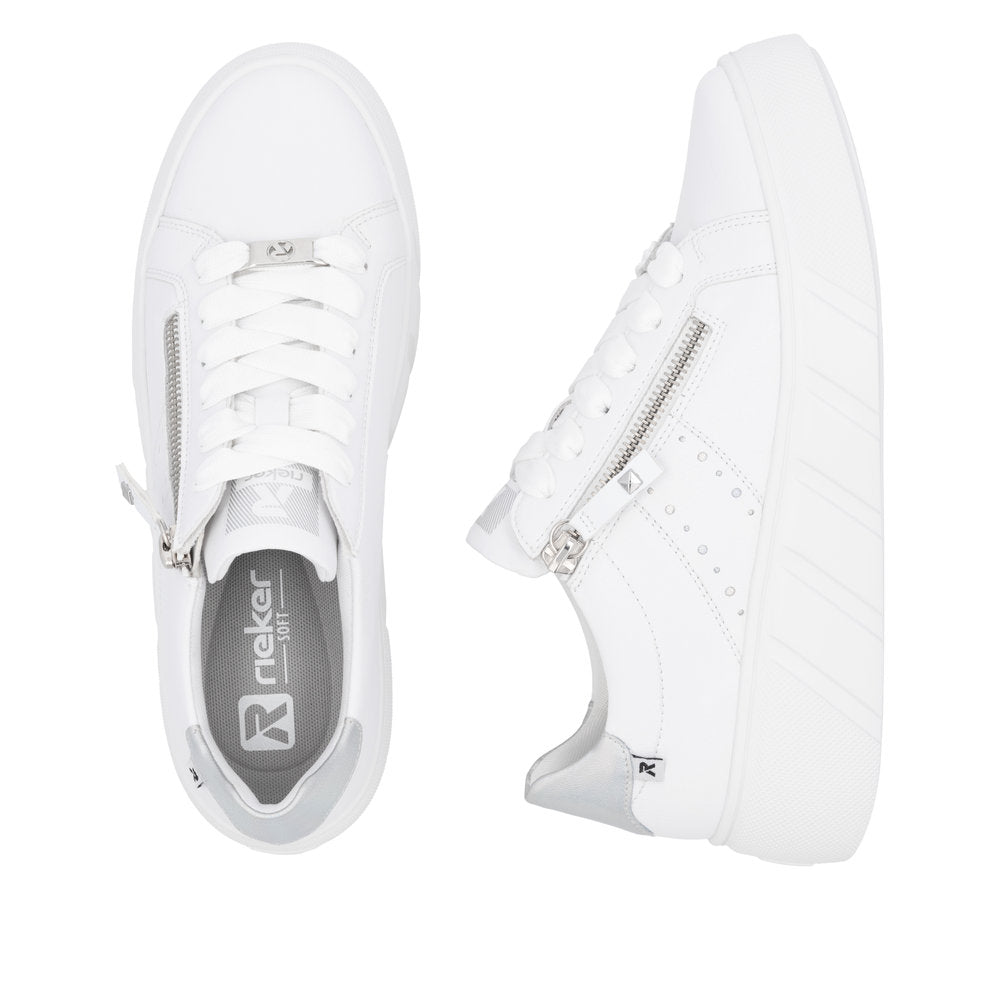 A pair of white sneakers, one shown from above, revealing the laces and soft insole, and the other shown from the side, highlighting a zipper detail and platform sole.