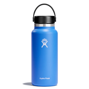 A blue Hydro Flask water bottle with a black lid and handle.