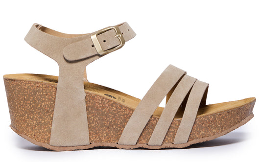 Beige suede wedge sandal with ankle strap and buckle closure, and three straps across the forefoot.