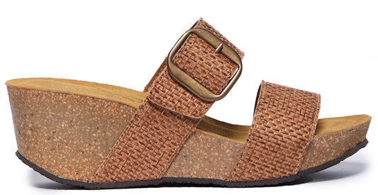 Woven fabric wedge sandal with a bronze buckle.