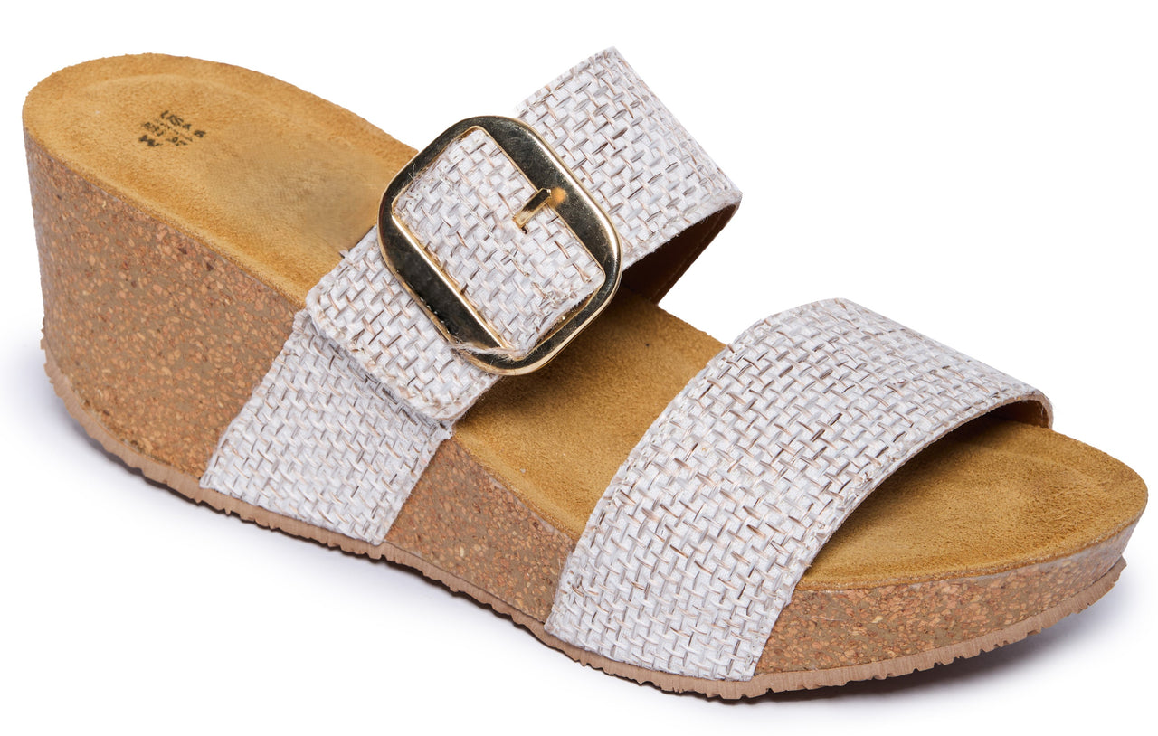Womens' sandal with a wide, gold buckle and cork wedge heel.