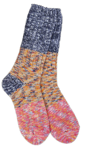 A pair of colorful knitted socks; the top is dark blue and gray, the middle is orange, yellow, and blue, and the bottom is pink, red, and orange.