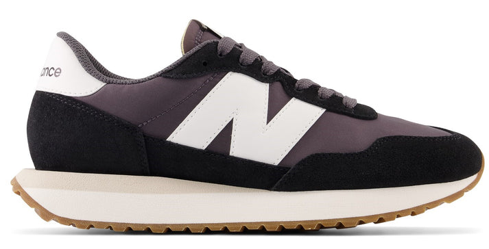 Black and gray sneaker with white side logo and light brown sole.