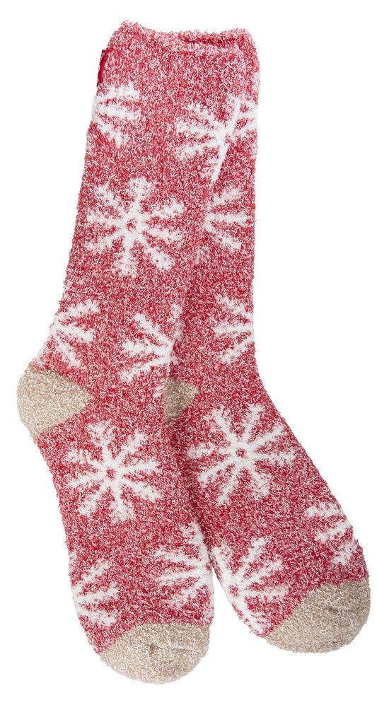 Pair of fuzzy socks, red with white snowflake design and tan toe and heel.