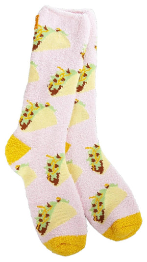 Pair of pink fuzzy socks with taco pattern and yellow toe and heel.