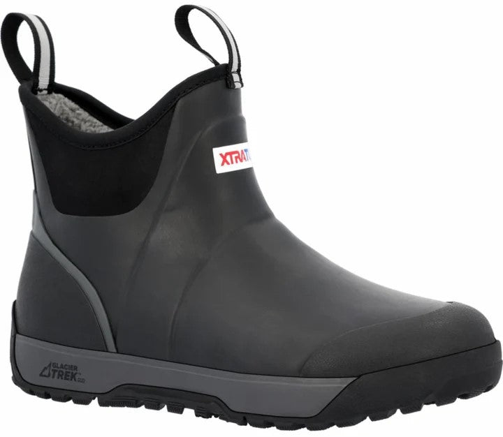A black ankle-height waterproof boot with pull tabs, a grey midsole, and the text XTRATUF visible on the side and GLACIER TREK on the heel.