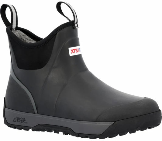 A black ankle-height waterproof boot with pull tabs, a grey midsole, and the text XTRATUF visible on the side and GLACIER TREK on the heel.