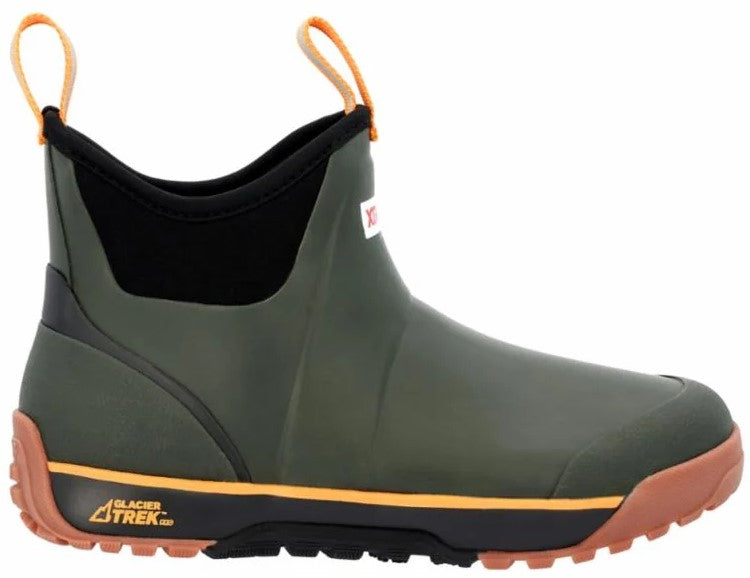 A slip-on ankle boot with an olive green rubber upper, a black neoprene collar, and two orange pull tabs. The midsole is black with an orange stripe, and the lugged outsole is brown. The text 'GLACIER TREK' is printed on the side of the heel.