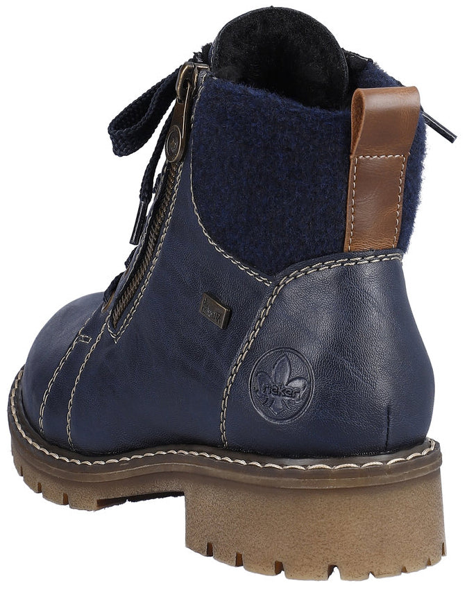 Navy blue ankle boot with laces and zipper, brown lug sole, and a leather heel tab.