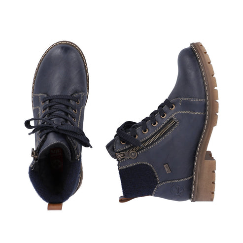 Two navy blue ankle boots, one seen from the toe and one on its side, with laces and side zippers, on a lug sole.