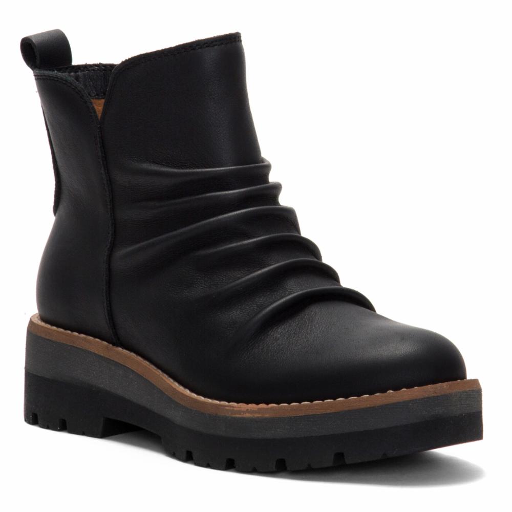 Black ankle boot with a thick, layered sole and a ruched upper.