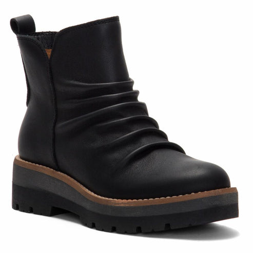 Black ankle boot with a thick, layered sole and a ruched upper.