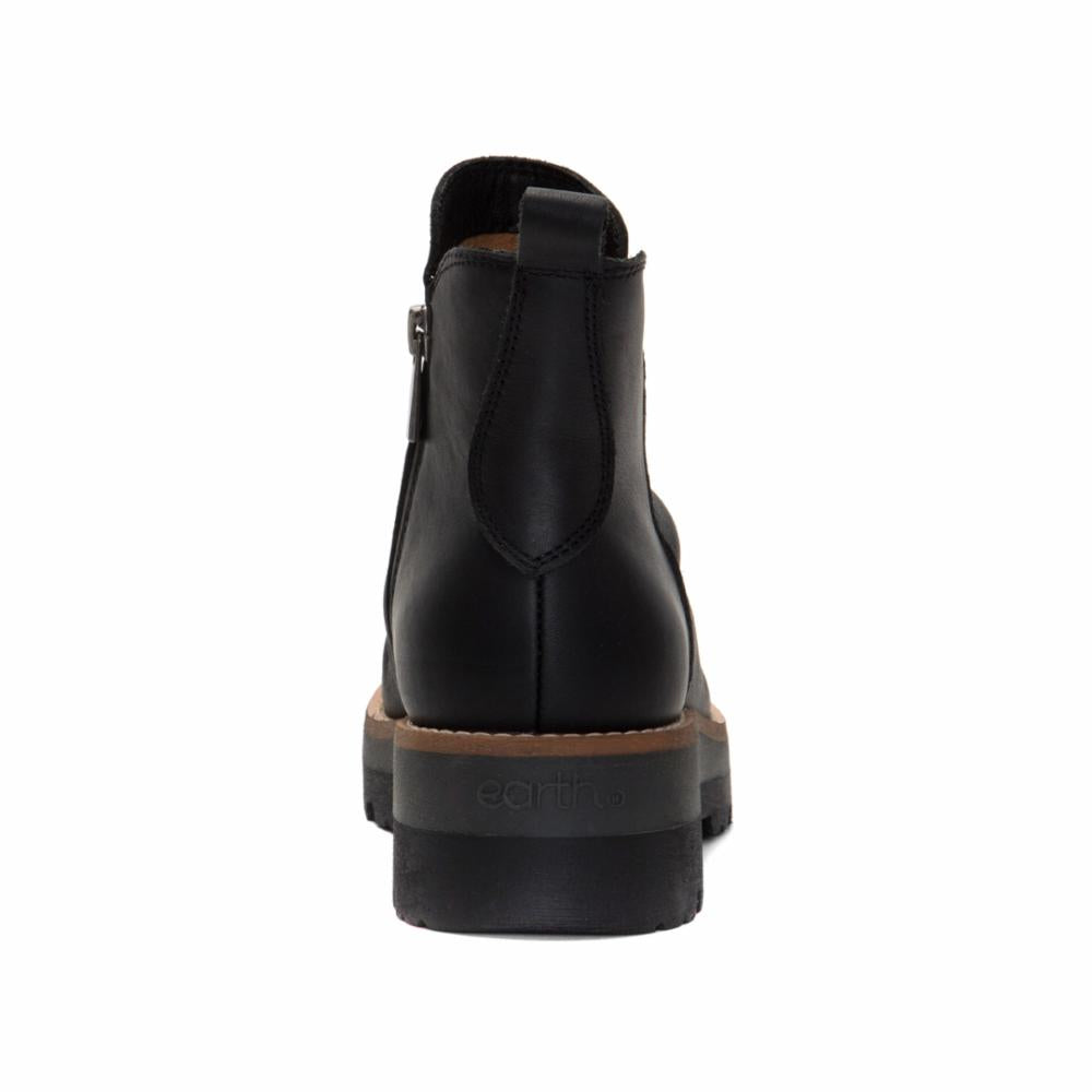 Rear view of a black, leather ankle boot with a side zipper and elastic ankle panel and a black lug sole.