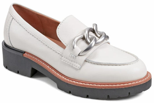 White patent leather penny loafer with a silver chain across the vamp and a lug sole.