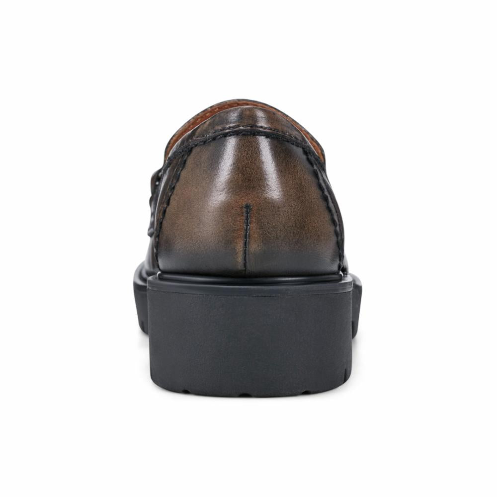 Rear view of a brown loafer with a black block heel.