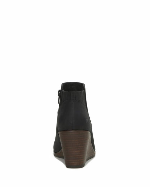 Back view of a black, heeled ankle boot with a side zipper.