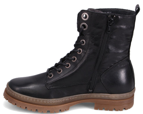 Black leather combat boot with laces, side zipper, and brown lug sole.