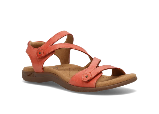 A coral-colored sandal with adjustable straps, a cushioned footbed, and a low platform sole.