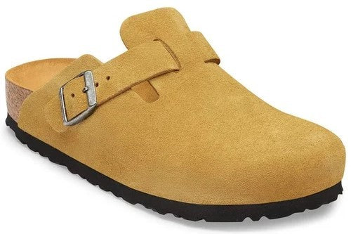 A yellow suede clog with a cork footbed, a black rubber sole, and an adjustable metal buckle strap over the instep.