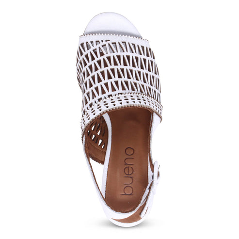 Overhead shot of a white peep-toe sandal with a geometric cut-out design on the vamp and a buckle strap.