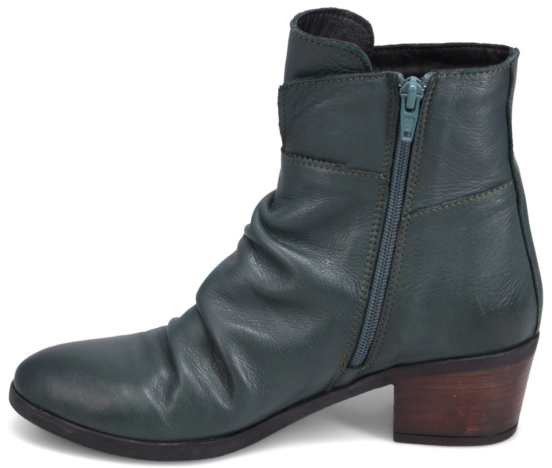 A teal leather ankle boot with a side zipper and a wooden heel.
