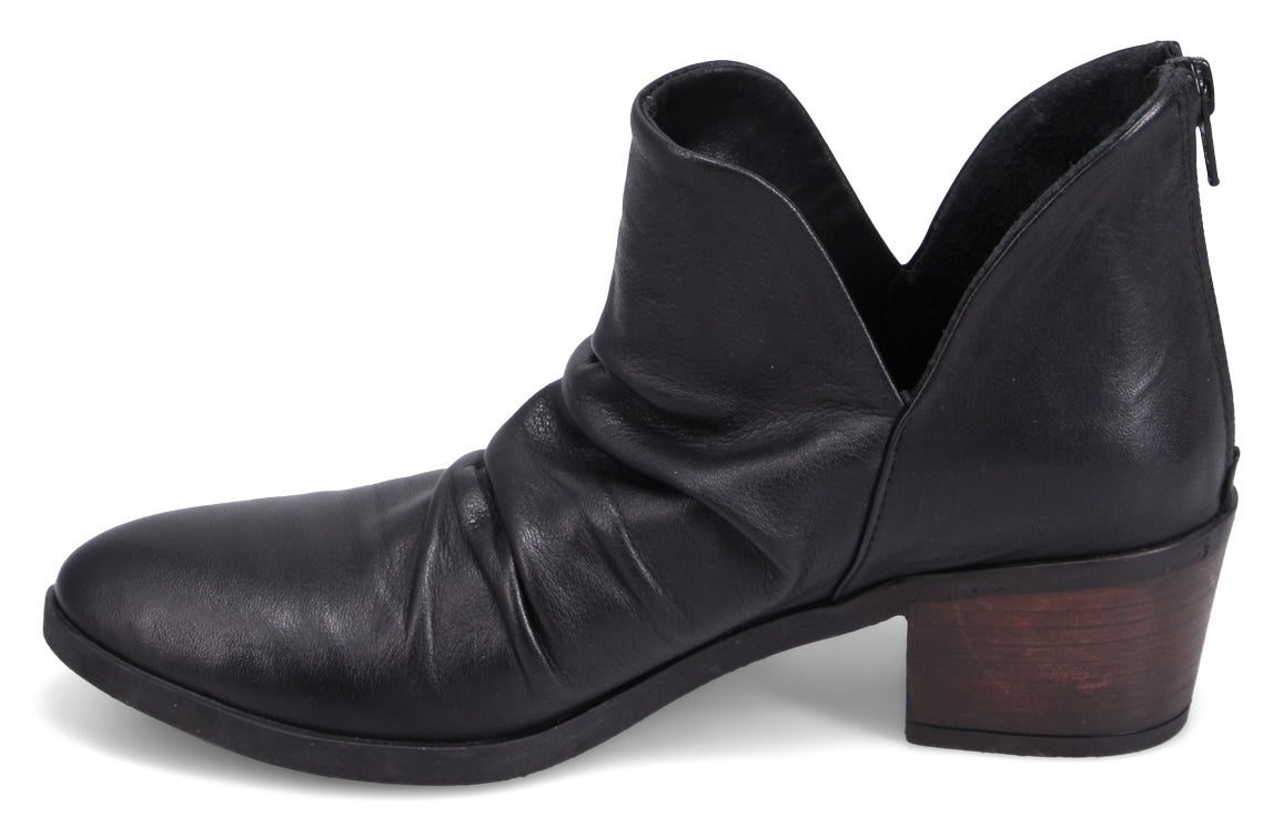 Black leather ankle boot with a short stacked heel, a V-cutout at the sides, and a back zipper.
