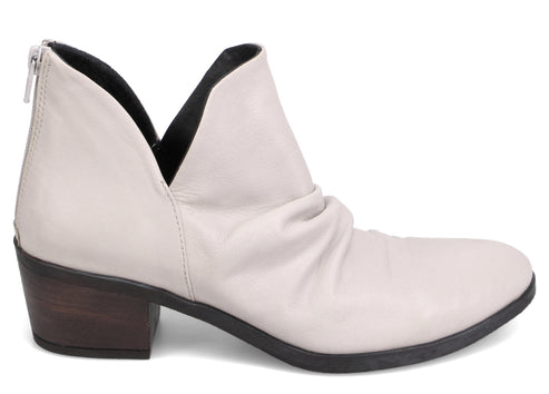 Off-white ankle boot with a mid-height block heel, black trim, and a rear zipper.