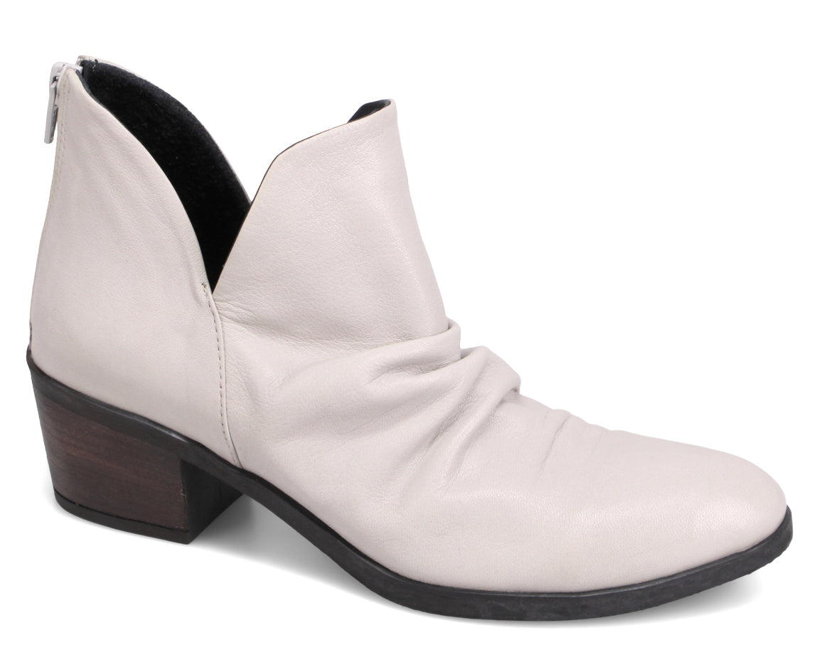 Ankle boot with a low block heel and a v-shaped opening.