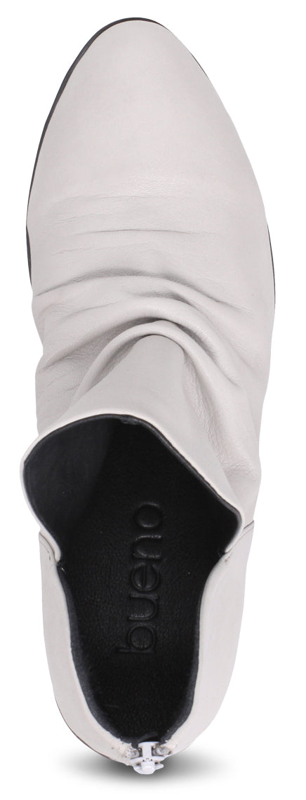 Top-down view of a white leather boot with elastic side panels and a slight heel.