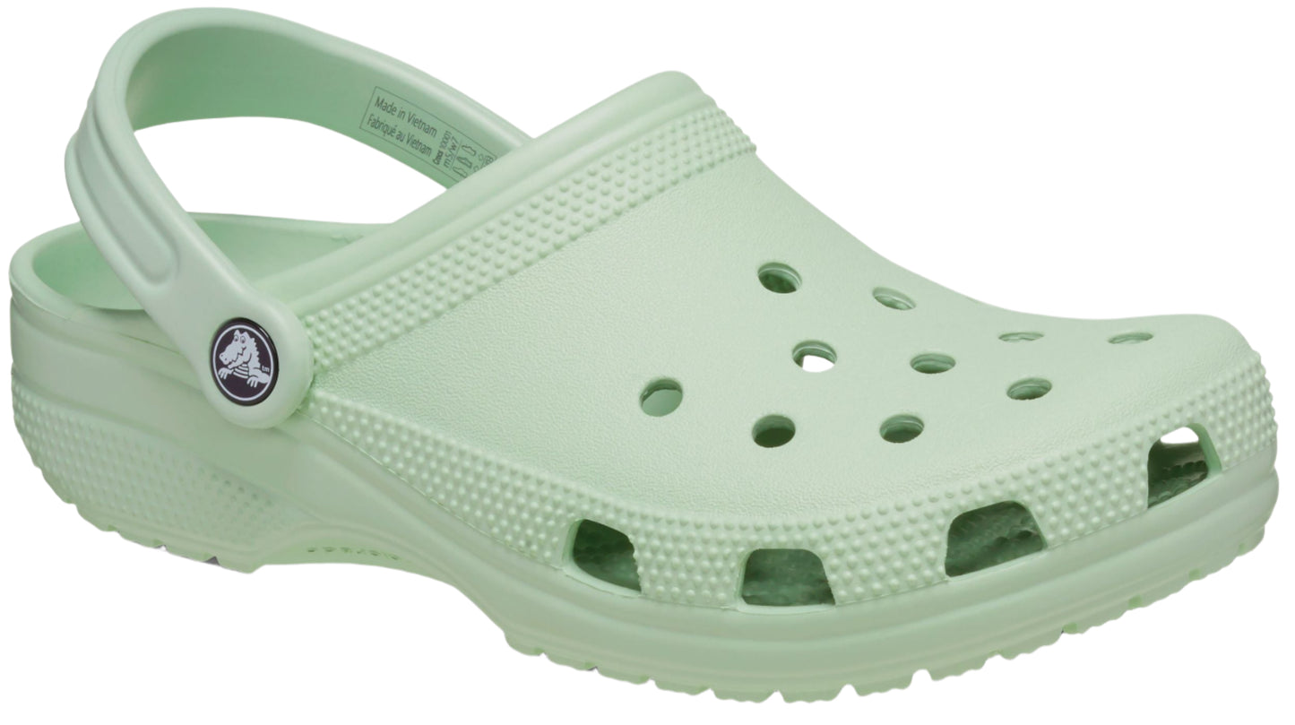 Light green clog with holes on the toe box and a pivoting heel strap.
