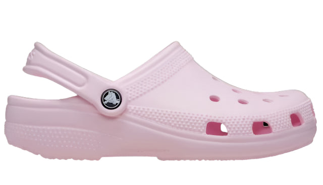 Side view of a pink clog-style shoe with ventilation holes and a pivoting back strap.