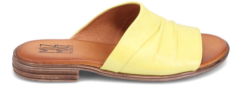 Yellow slip-on sandal with stacked heel and slightly twisted strap.
