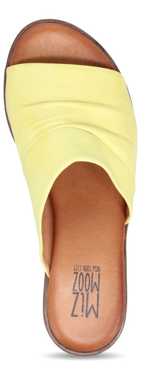 A yellow slide sandal with an open toe and the brand "MIZ MOOZ NEW YORK CITY" printed on the insole.